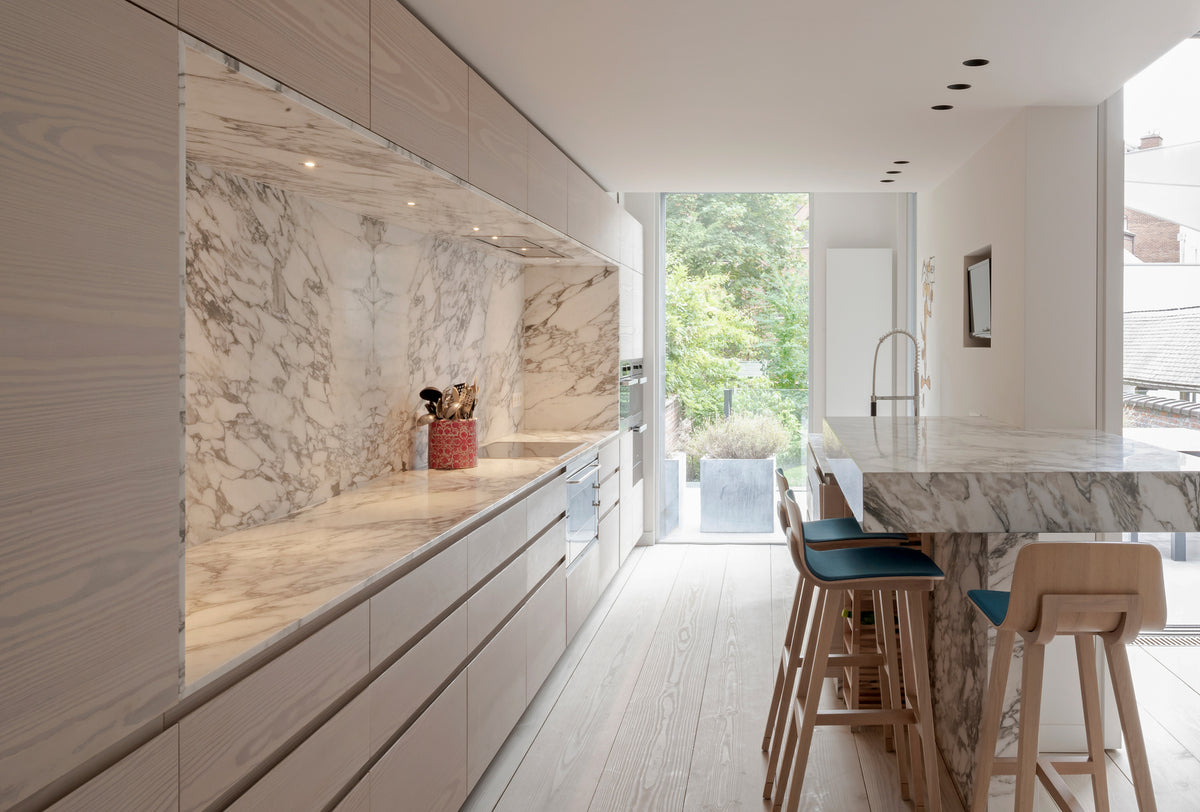 Bright modern kitchen with white oak floor and marble island